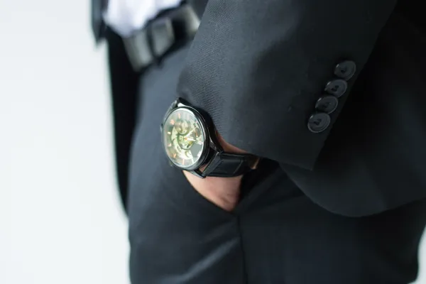 Businessman hand in pants pocket. Closeup of watch on male ceo wrist. Luxury an fashion concept