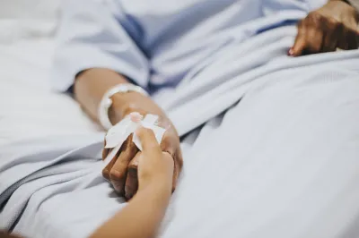 Daughter holding her mothers hand in the hospital, freepik