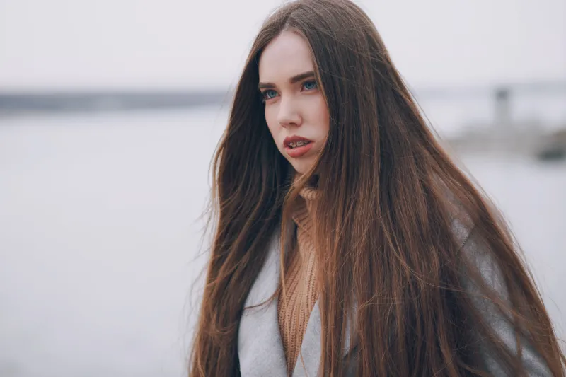 beautiful girl in the city on a gray coat